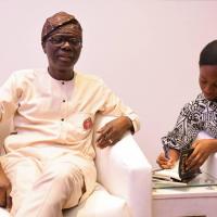 Munachi Mbonu signs a copy of Father's Will for Governor Sanwoolu